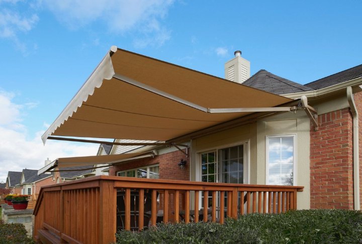 SunPro awning over a backyard deck SunPro motorized retractable awning over a backyard deck
