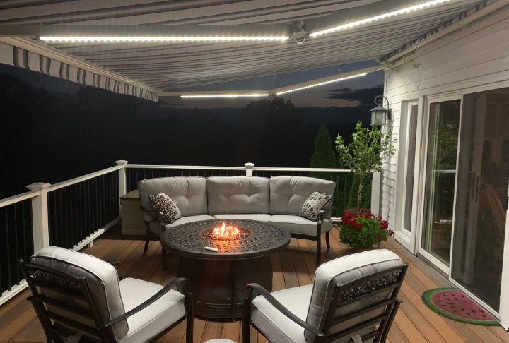 SunPro awning LED lights at night SunPro awning with LED arm lights over a deck at night